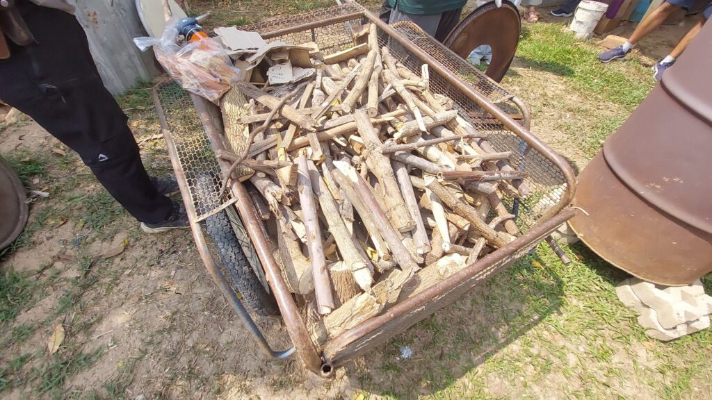 Collected wood and crop residues as feedstock for biochar production, ready for pyrolysis.